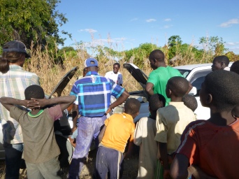 Villagers watch as we jump the battery.