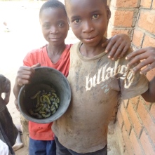 Bwalya poses with a new friend, who came to Mfuba with his family to harvest caterpillars.