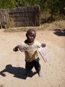 Kamfwa, dancing with his school notebook on a homework-free day.