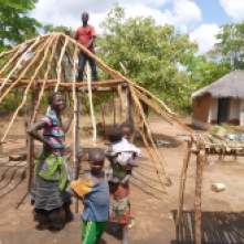 Bana Kessia and Bashi Kessia (up top) building a new nsaka at their home.