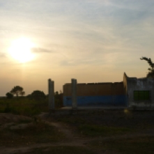 Sunset behind an abandoned building in the village of Nsombo.
