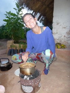PCV Christina cooking over her charcoal brazier.